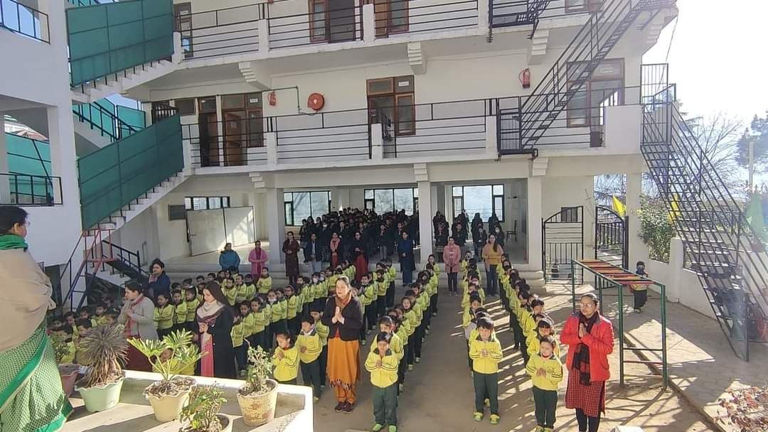 Morning assembly at Kids Planet — students in uniform in the school courtyard